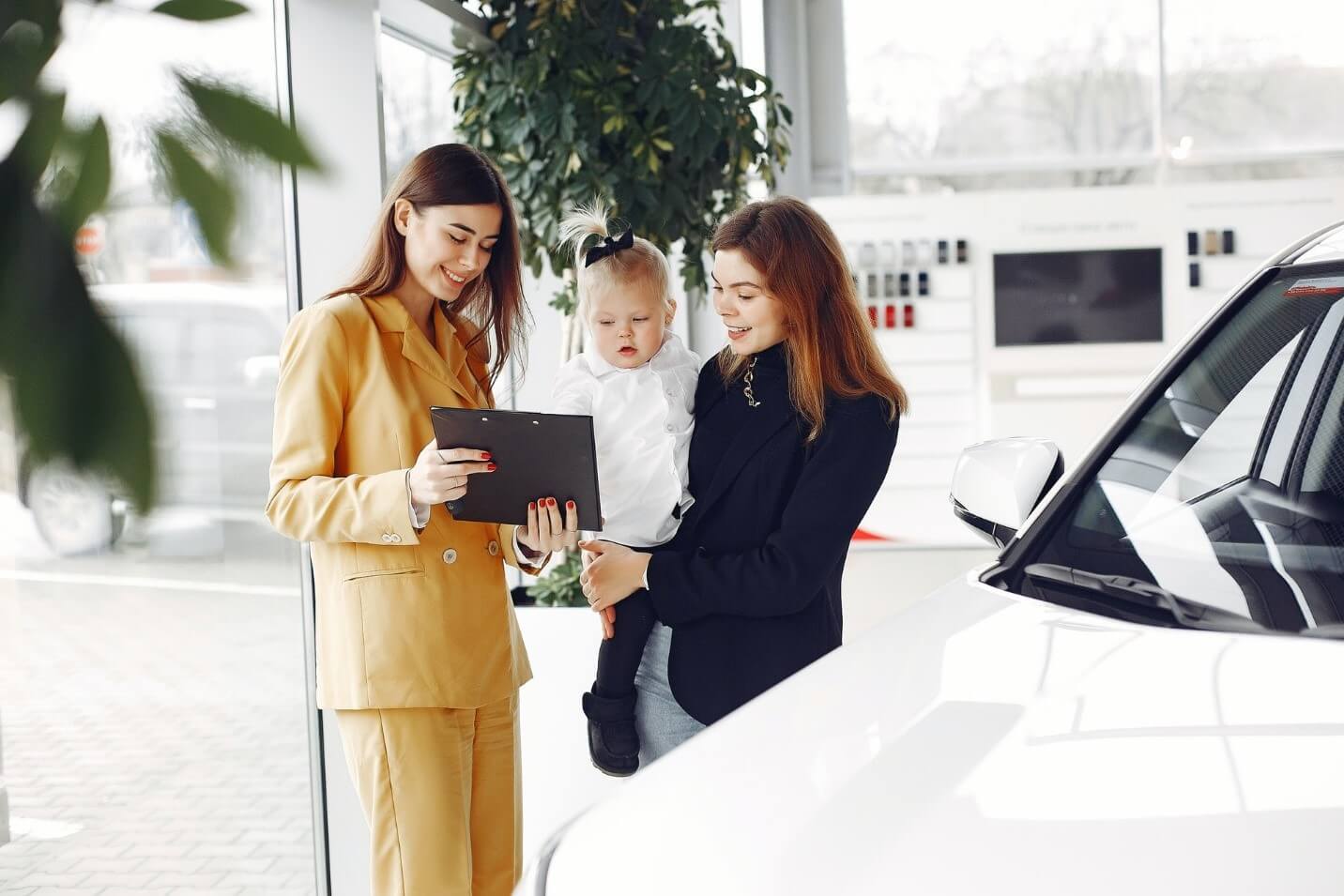 photo of woman car shopping with child